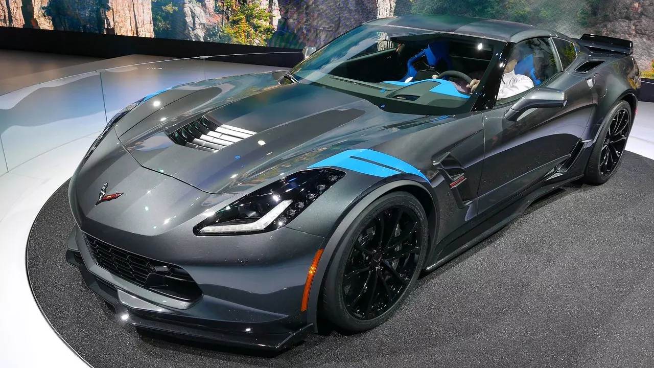 A gray sports car with blue stripes on the hood.